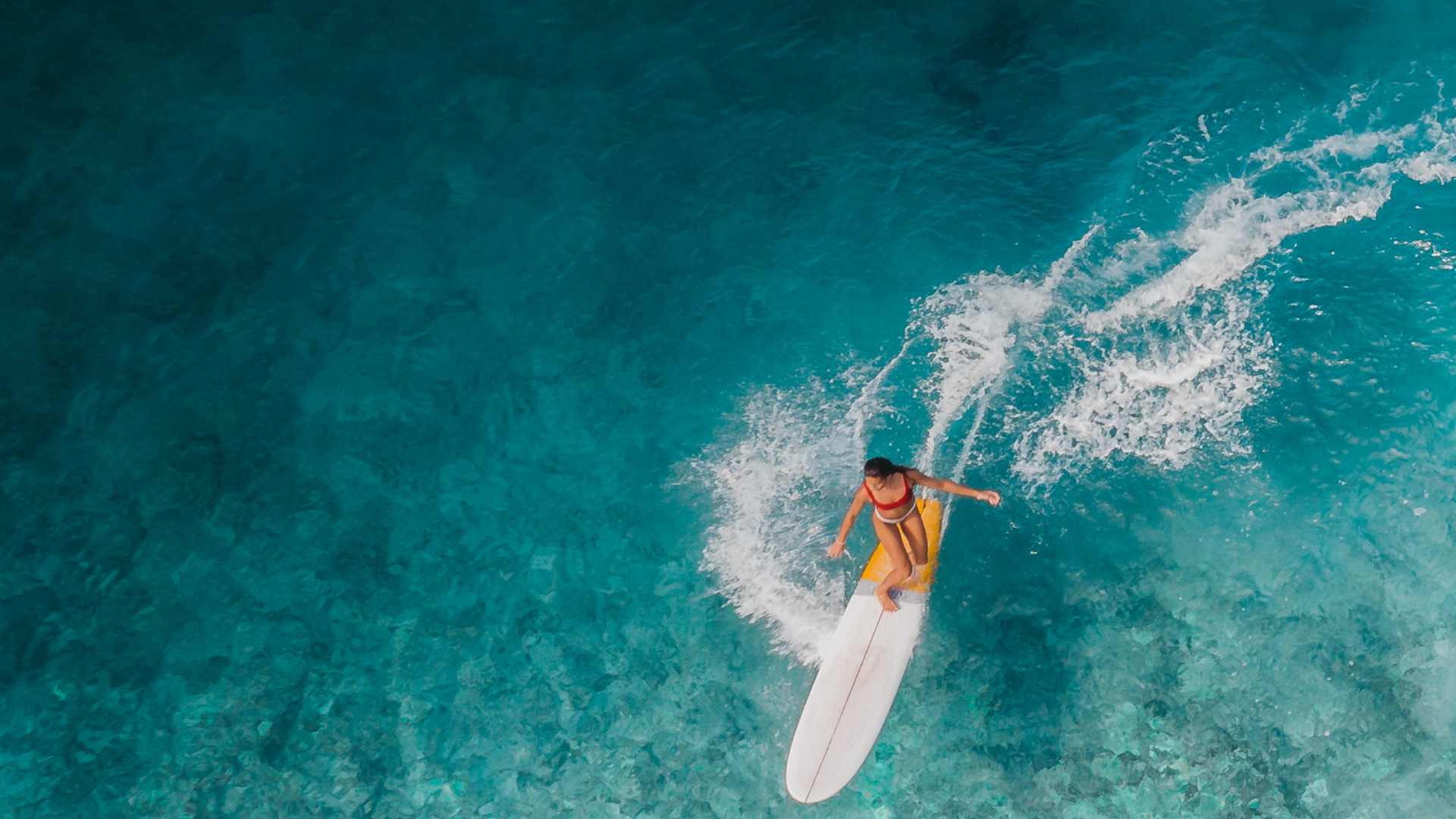 femme qui surf sur la mer