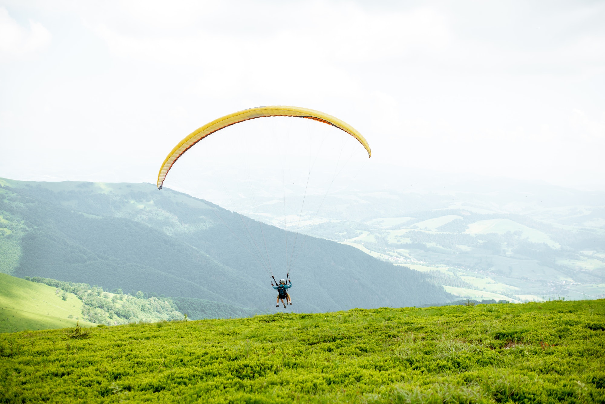 Men starting a paraglider flight